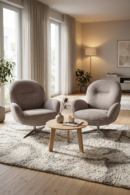Two grey Estelle armchairs flank a small wooden table in a bright, modern living room.