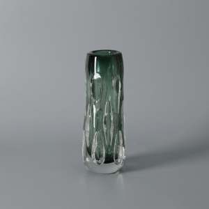 A textured column with a deep green tint and a cave-like surface. Great for a single stem or as a layered styling piece. Adds quiet drama to corners, mantels, and entry tables