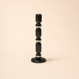 A decorative candle Stand staged on a console table